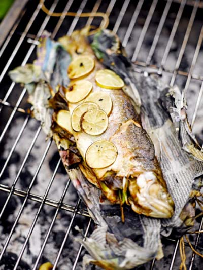 Barbecued trout in newspaper